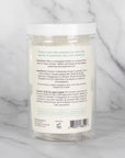 The back view of the container of Scentral Zone Shower Steamer in scent Peppermint + Eucalyptus explaining the ingredients and directions of how to use.