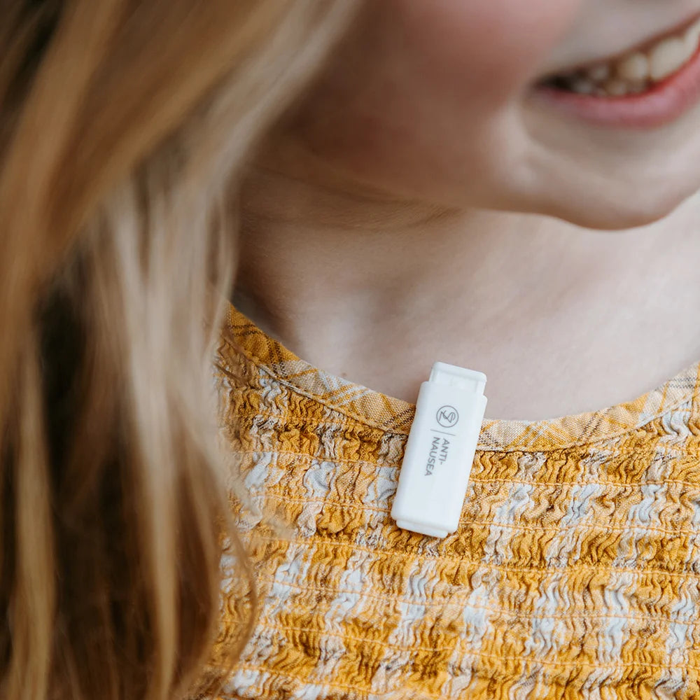 Close up of a child wearing Scentral Zone Clip-On Diffuser on the collar of the shirt.