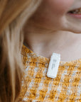 Close up of a child wearing Scentral Zone Clip-On Diffuser on the collar of the shirt.