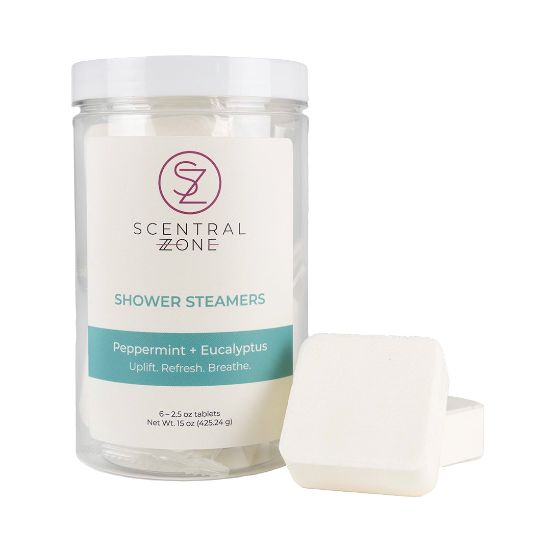 Scentral Zone shower steamers in Peppermint + Eucalyptus scent in a clear container with a white background. Two shower steamer tablets are leaning next to the container.