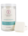 Scentral Zone shower steamers in Peppermint + Eucalyptus scent in a clear container with a white background. Two shower steamer tablets are leaning next to the container.