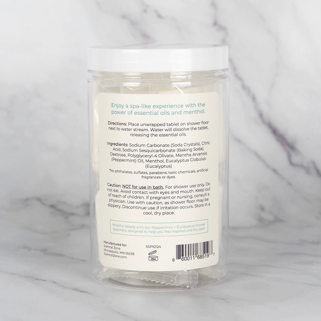 The back view of the container of Scentral Zone Shower Steamer in scent Peppermint + Eucalyptus explaining the ingredients and directions of how to use. 