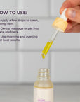 Hand model holding the white dropper top of Scentral Zone's 0.5 fl oz Velvet Face Serum, a yellow rejuvenating serum with cucumber and seaweed, in a glass dropper bottle. Text is displayed next to the dropper explaining how to apply the product and when to use it for best results. 